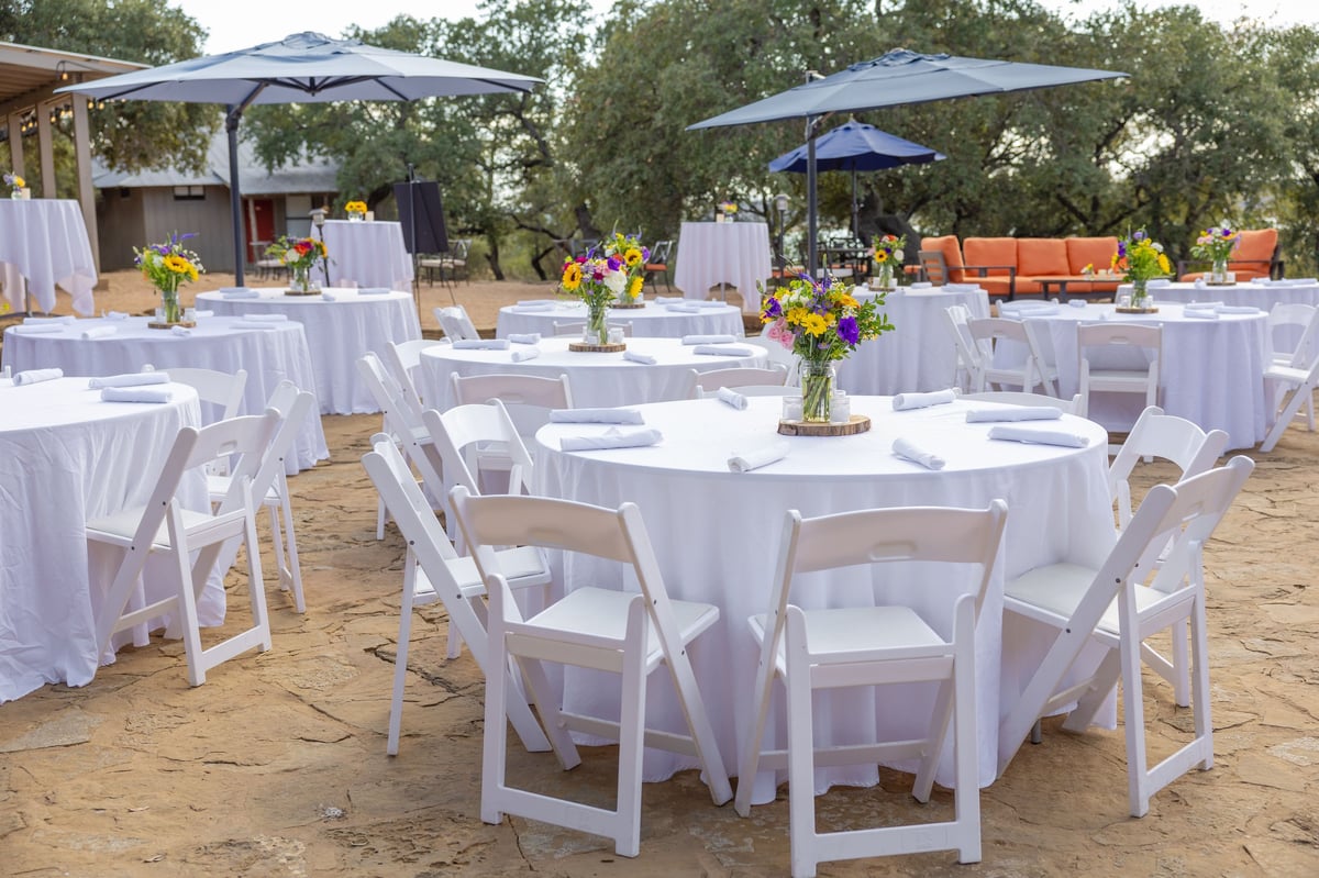 Event table linens and chair covers rentals in white floor-length styling