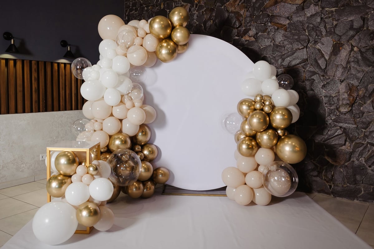 Party decoration photo zone with a balloon arch and custom banner backdrop