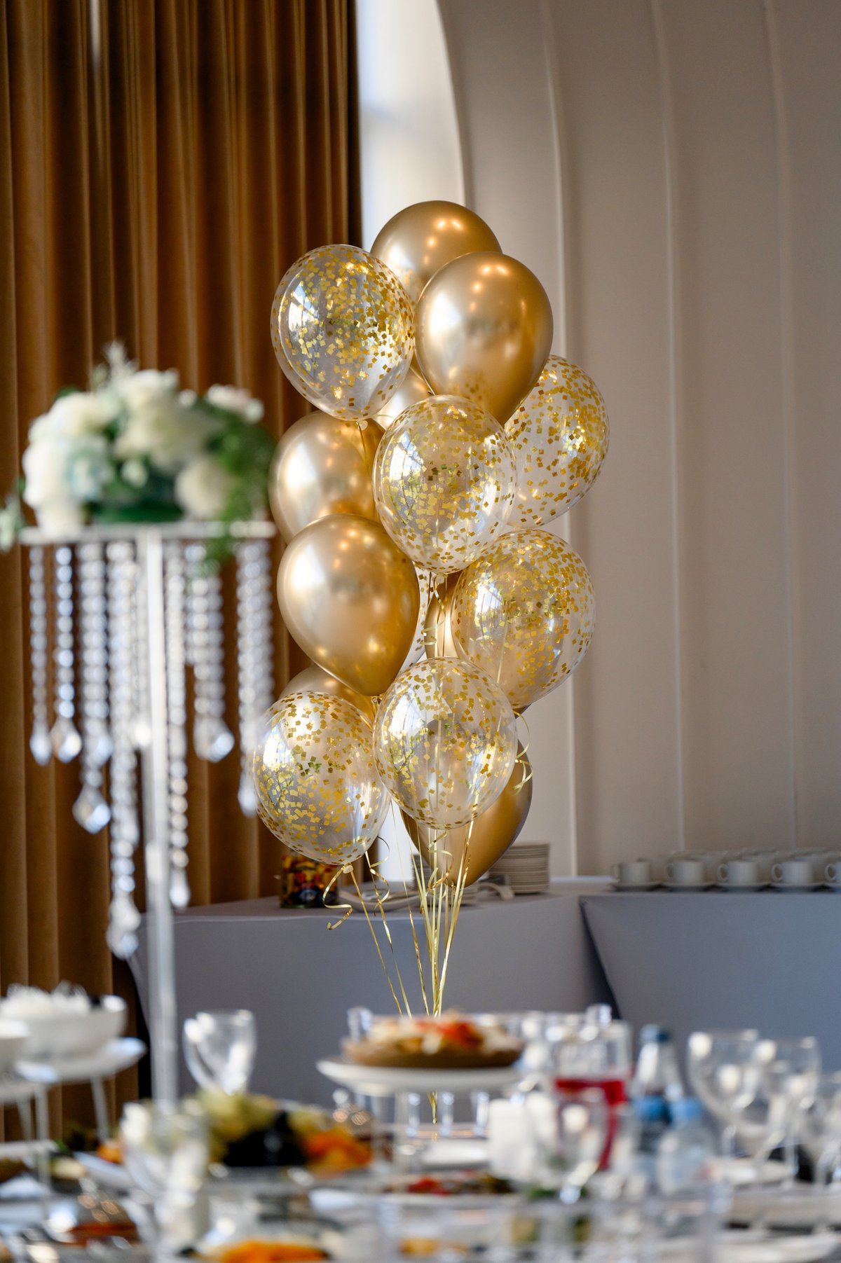 Custom centerpiece rentals with gold balloons and confetti at a party table